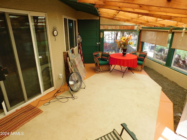 sunroom / solarium featuring lofted ceiling