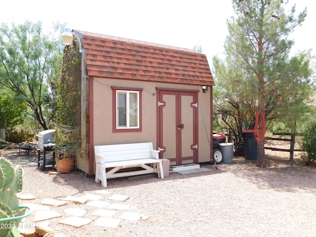 view of shed featuring fence