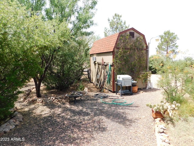 view of shed featuring a fire pit