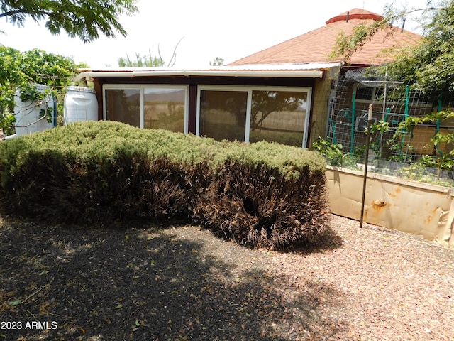 back of property featuring a garden