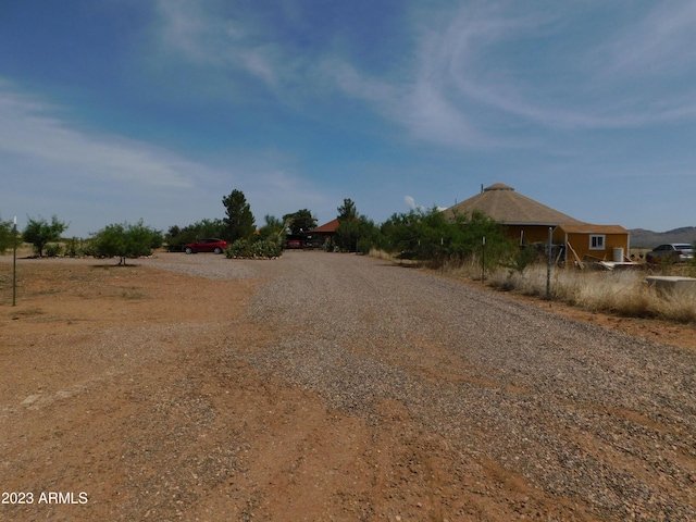 view of road with gravel driveway