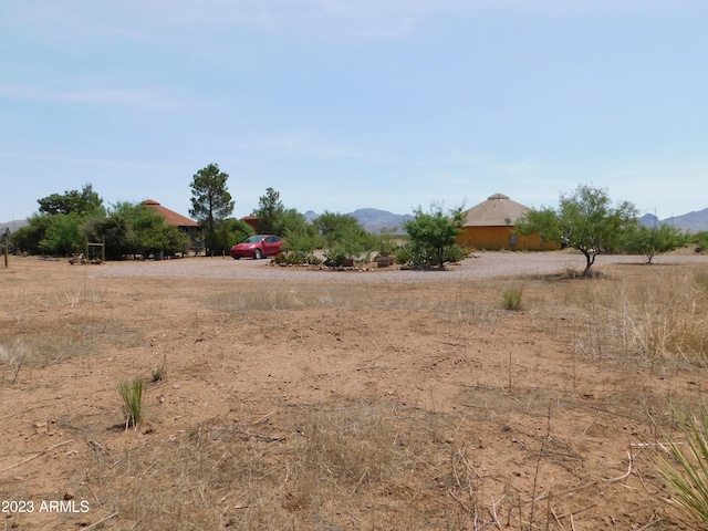 view of yard with a mountain view and a rural view