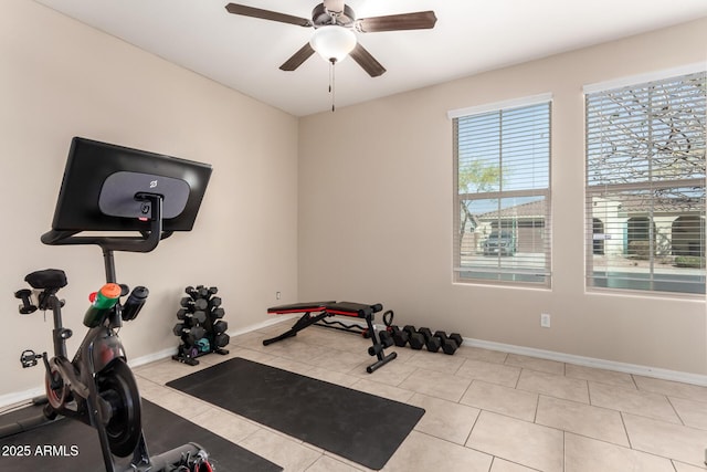 exercise room featuring tile patterned floors, baseboards, and ceiling fan