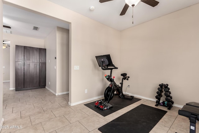 exercise area with light tile patterned floors, visible vents, baseboards, and ceiling fan