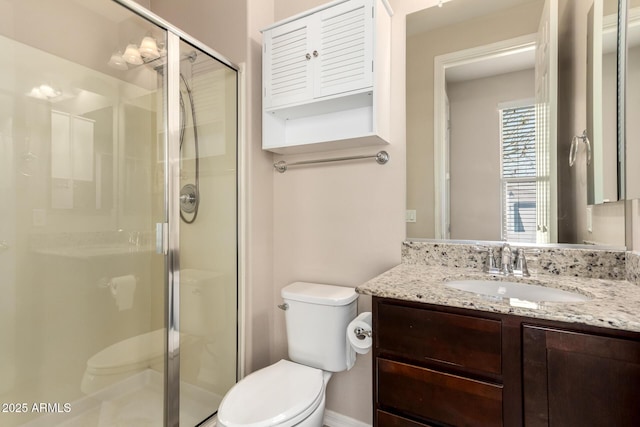 full bath featuring vanity, toilet, and a shower stall