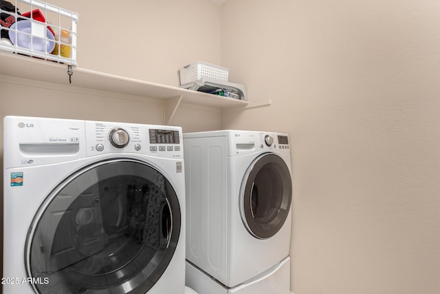 laundry area featuring washing machine and clothes dryer and laundry area