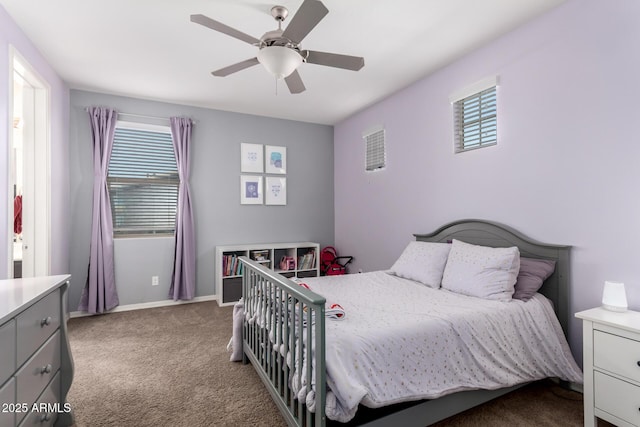 carpeted bedroom featuring baseboards and a ceiling fan