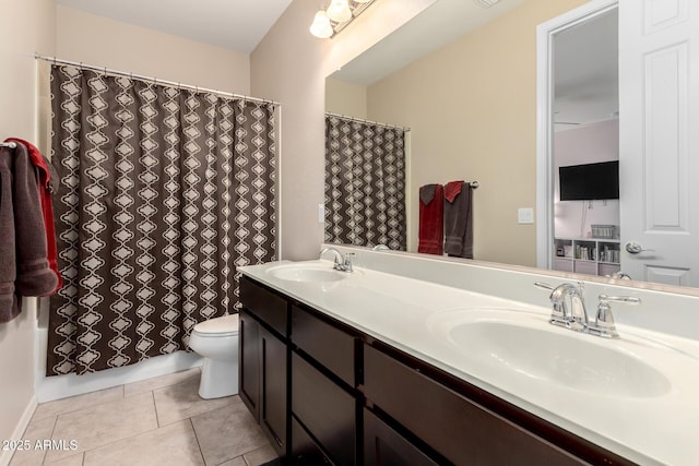 full bathroom with a sink, toilet, double vanity, and tile patterned floors