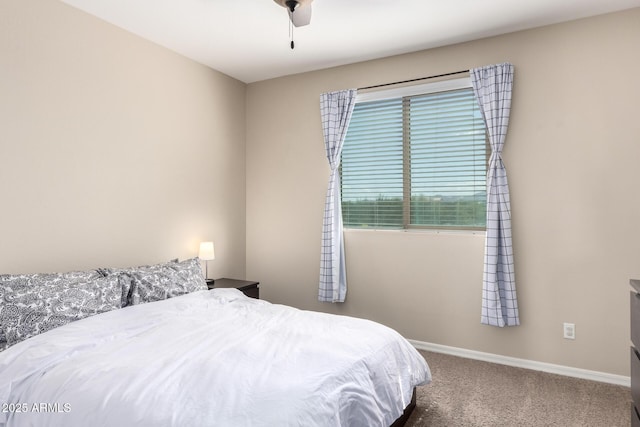 carpeted bedroom featuring baseboards and ceiling fan