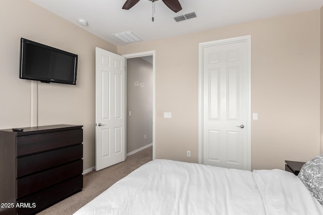 carpeted bedroom with visible vents, a ceiling fan, and baseboards