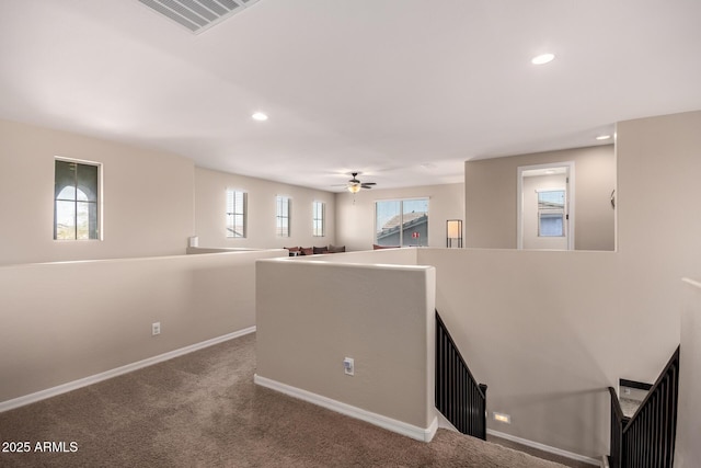 interior space with visible vents, carpet floors, baseboards, recessed lighting, and ceiling fan