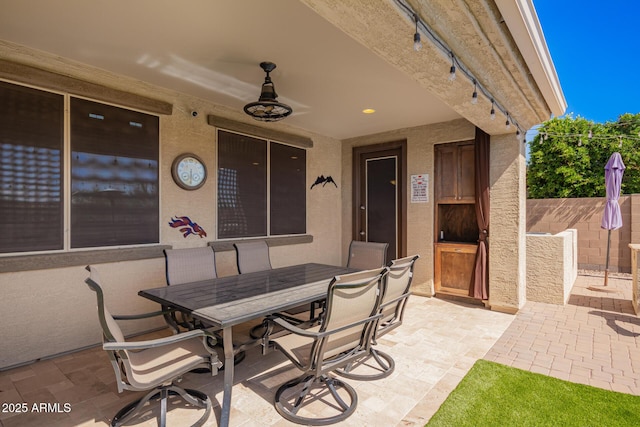 view of patio / terrace with outdoor dining area and fence