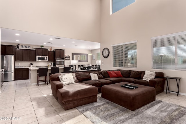 living room with plenty of natural light, recessed lighting, and light tile patterned floors