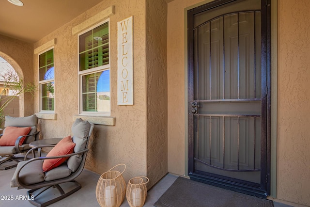 view of exterior entry with stucco siding