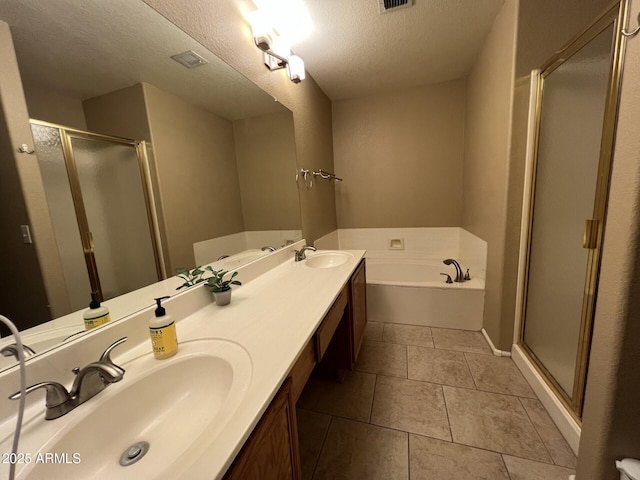 19943 N 77th Ave, Glendale, AZ 85308 - bathroom with a bath, a shower stall, double vanity, a textured ceiling, and tile patterned flooring
