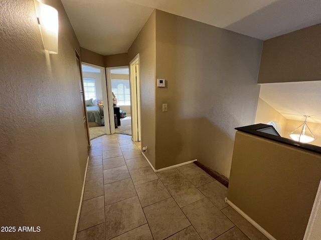 19943 N 77th Ave, Glendale, AZ 85308 - hallway featuring light tile patterned flooring and a textured wall