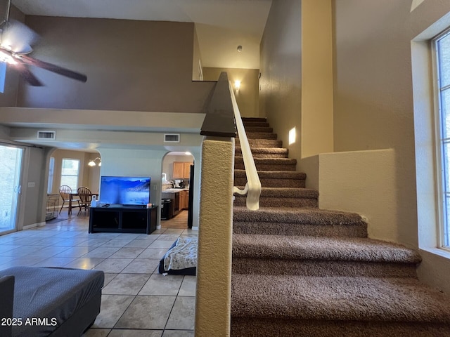 19943 N 77th Ave, Glendale, AZ 85308 - stairway featuring arched walkways, tile patterned floors, a high ceiling, and a ceiling fan