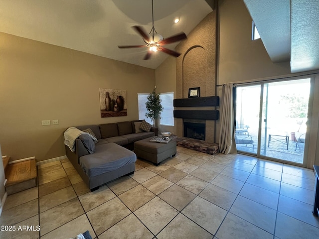 19943 N 77th Ave, Glendale, AZ 85308 - living room featuring light tile patterned flooring, high vaulted ceiling, a ceiling fan, and a large fireplace