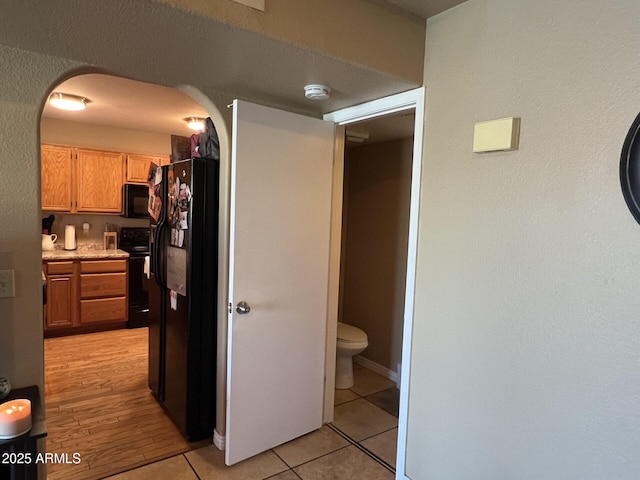 19943 N 77th Ave, Glendale, AZ 85308 - hallway with light tile patterned floors and arched walkways