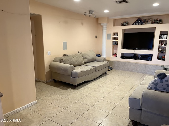 tiled living room with built in features and decorative columns