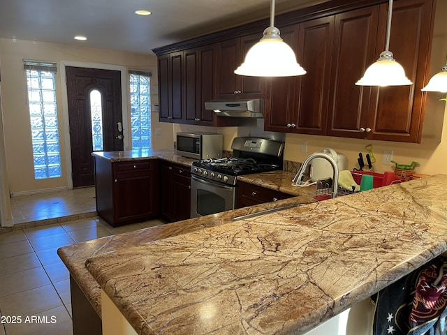 kitchen with pendant lighting, sink, appliances with stainless steel finishes, light tile patterned flooring, and kitchen peninsula