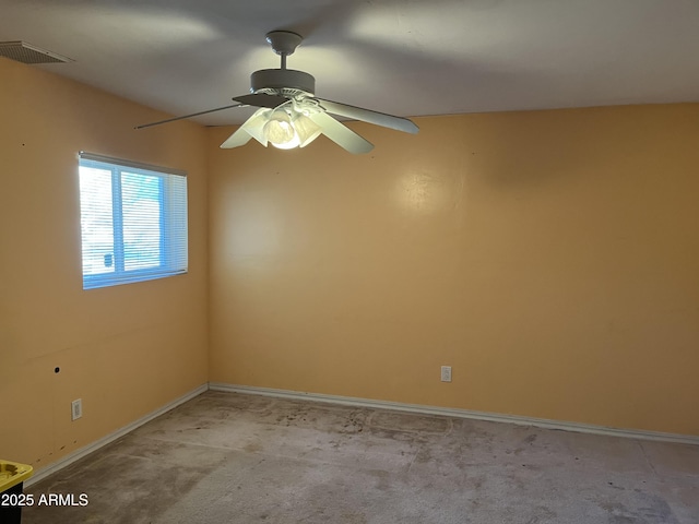 carpeted spare room with ceiling fan