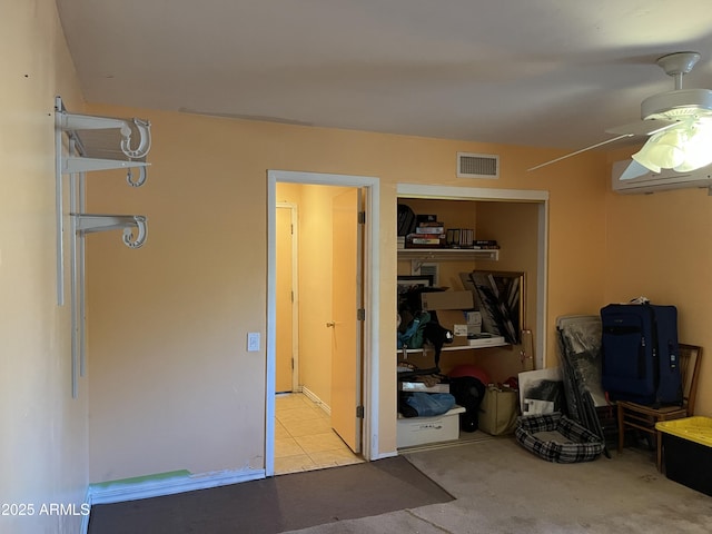 storage with a wall mounted air conditioner and ceiling fan