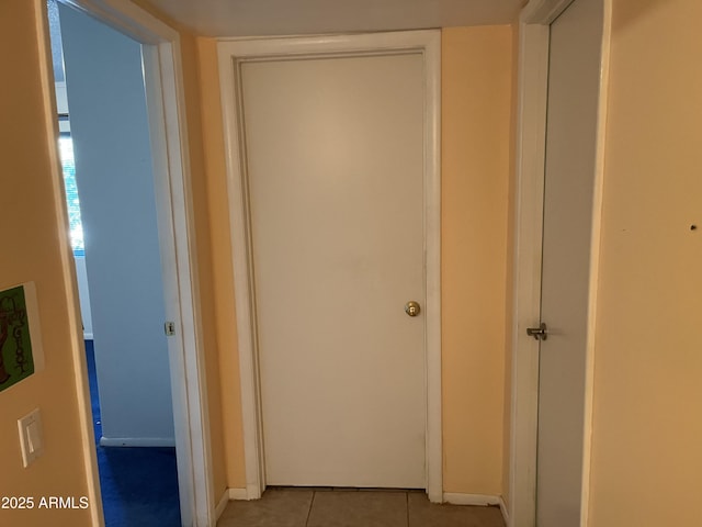 corridor featuring light tile patterned floors