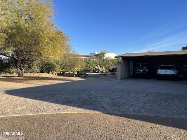 view of parking / parking lot featuring a carport