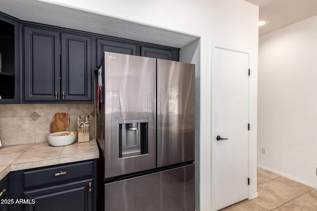 12642 N Mountainside Dr Unit B, Fountain Hills, AZ 85268 - kitchen with stainless steel fridge, tasteful backsplash, light countertops, light tile patterned flooring, and baseboards