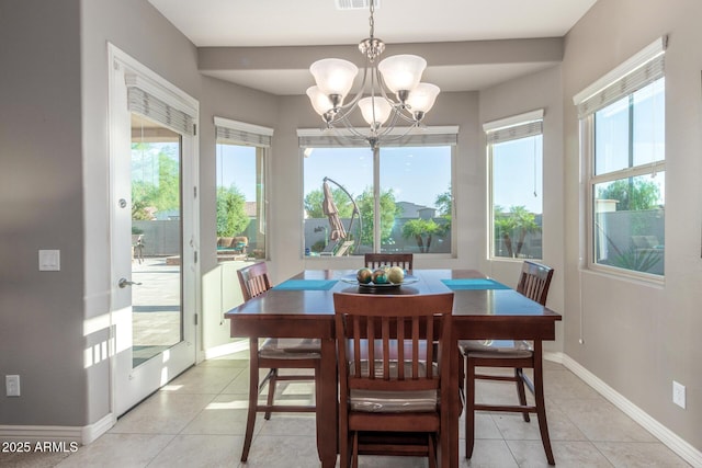 dining space featuring healthy amount of natural light, light tile patterned floors, and baseboards