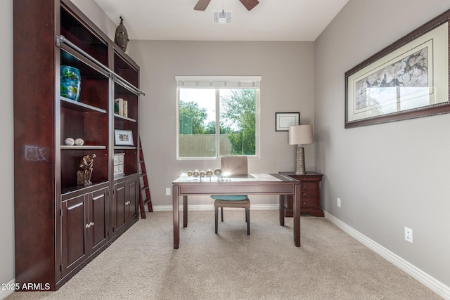 office area with ceiling fan, light carpet, and baseboards