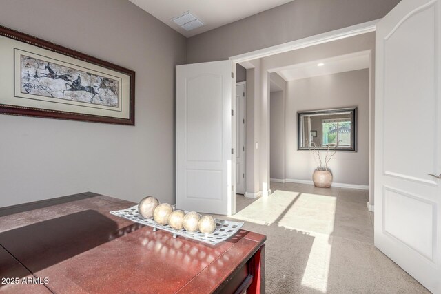 office area with light colored carpet and baseboards