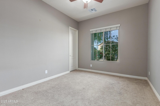 unfurnished room featuring a ceiling fan, light colored carpet, and baseboards