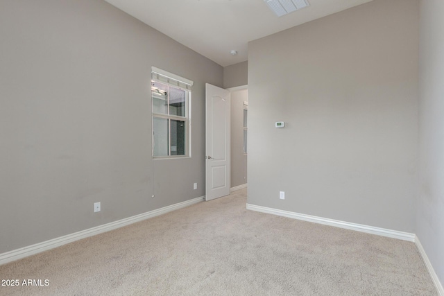 carpeted empty room with baseboards