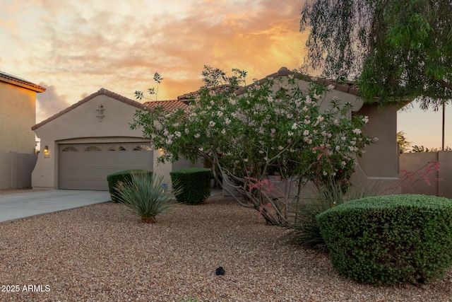 view of front of home with driveway, stucco siding, and an attached garage