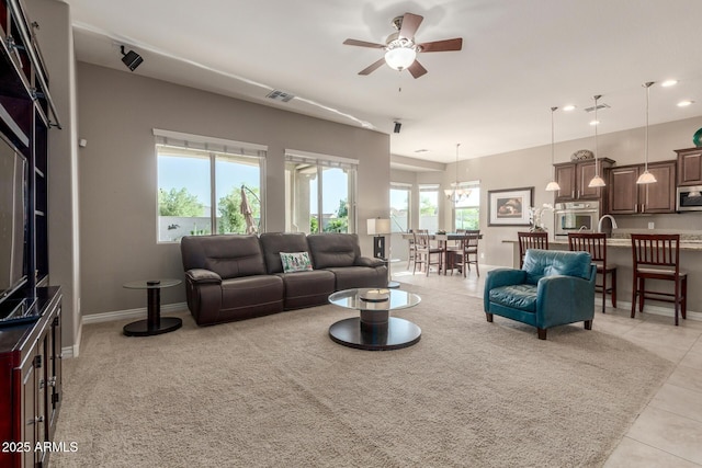 living room with a ceiling fan, light tile patterned floors, recessed lighting, and baseboards