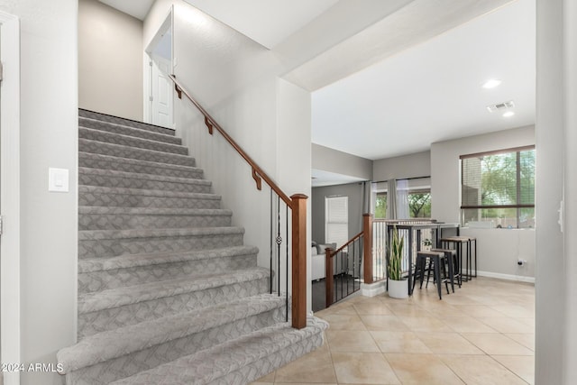 stairs featuring tile patterned flooring