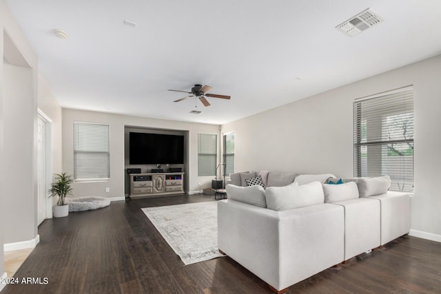 living room featuring dark hardwood / wood-style floors and ceiling fan