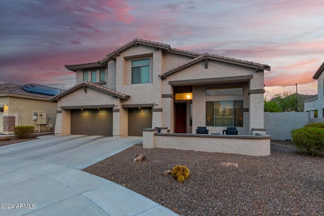 view of front property featuring a garage and solar panels