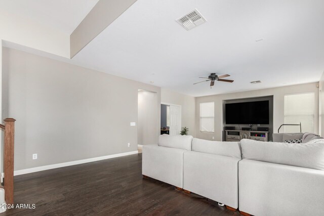 living room featuring dark hardwood / wood-style flooring and ceiling fan