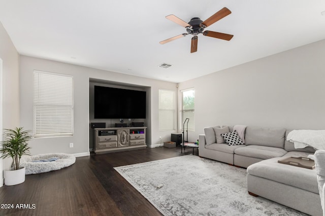 living room with ceiling fan and dark hardwood / wood-style flooring