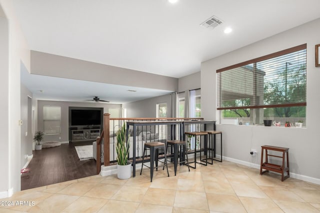 dining area featuring ceiling fan and light tile patterned floors