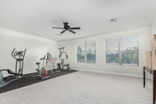 workout area featuring dark carpet and ceiling fan