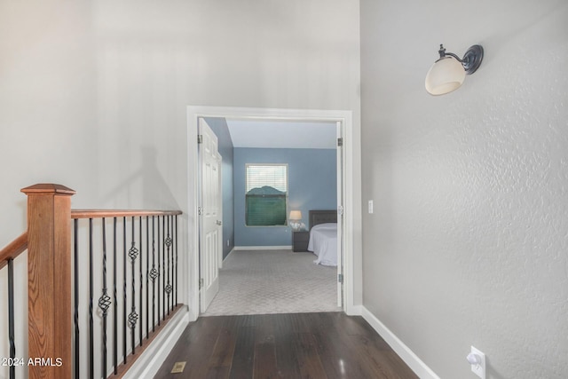 hallway with dark hardwood / wood-style floors