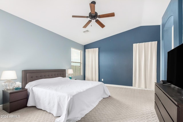 bedroom with vaulted ceiling, light carpet, and ceiling fan