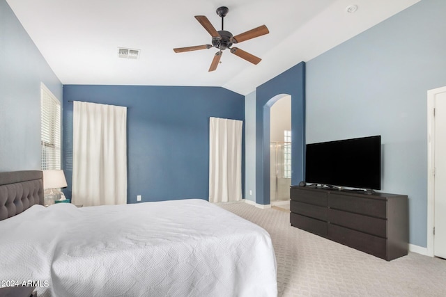 bedroom with ceiling fan, light colored carpet, lofted ceiling, and multiple windows