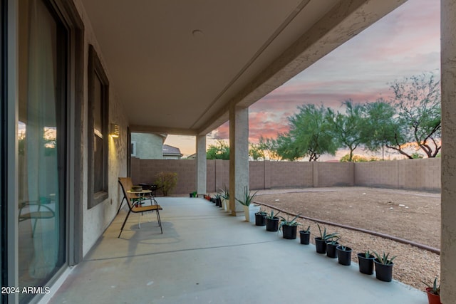 view of patio terrace at dusk