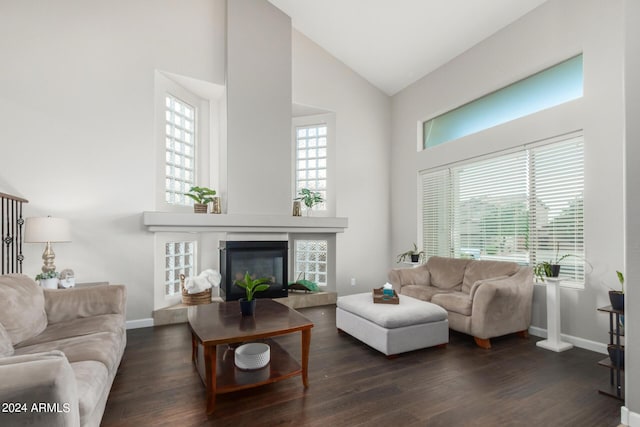 living room with high vaulted ceiling, a wealth of natural light, and dark hardwood / wood-style flooring