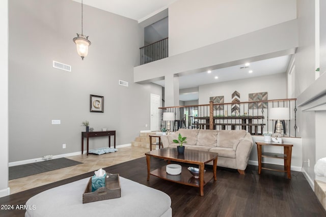 living room with hardwood / wood-style flooring and a high ceiling